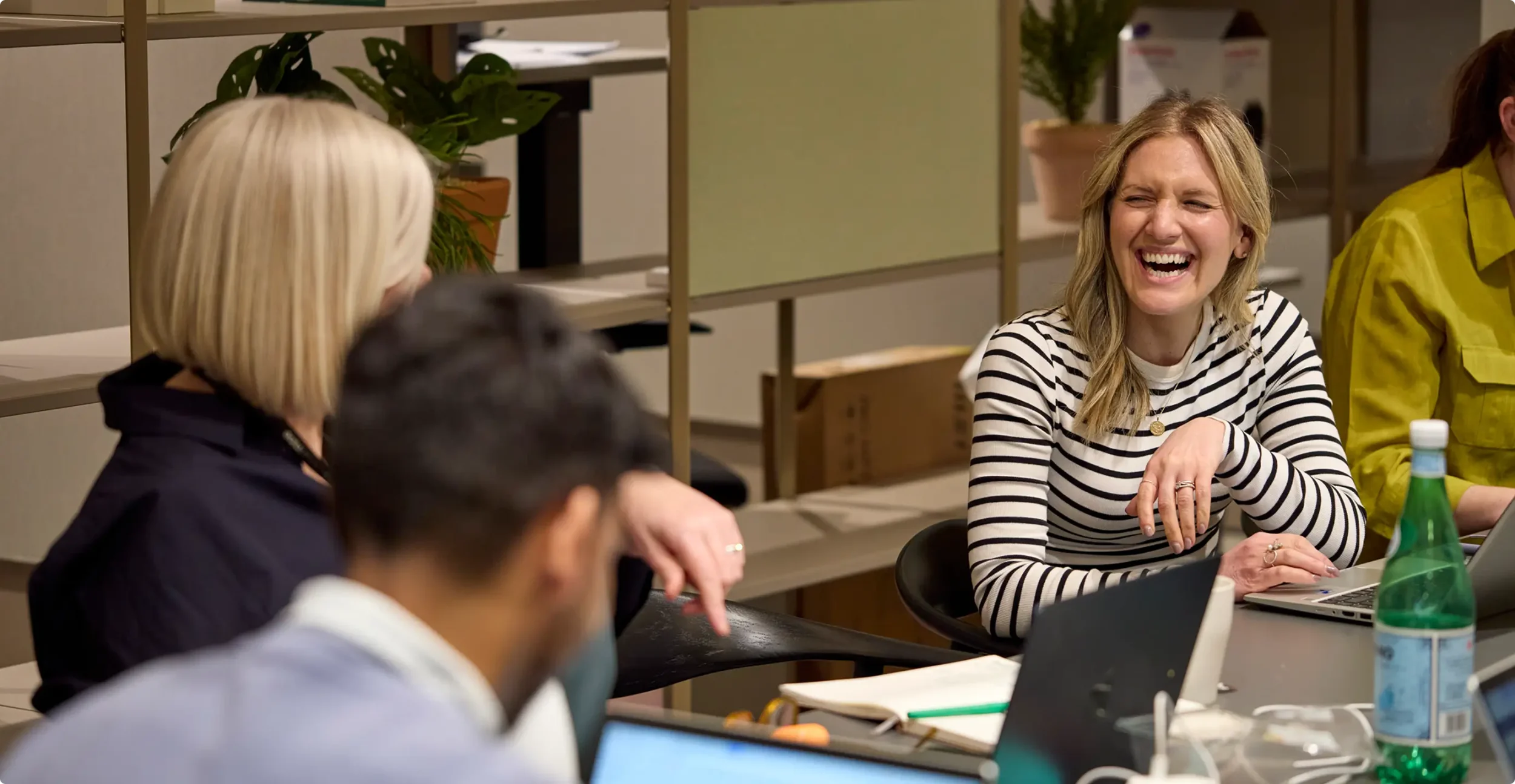 A woman laughing during a business meeting